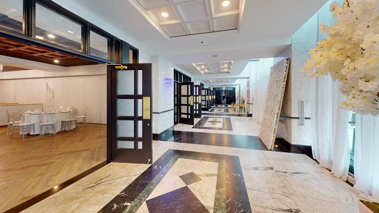 Corporate room with dressed tables and a central event area